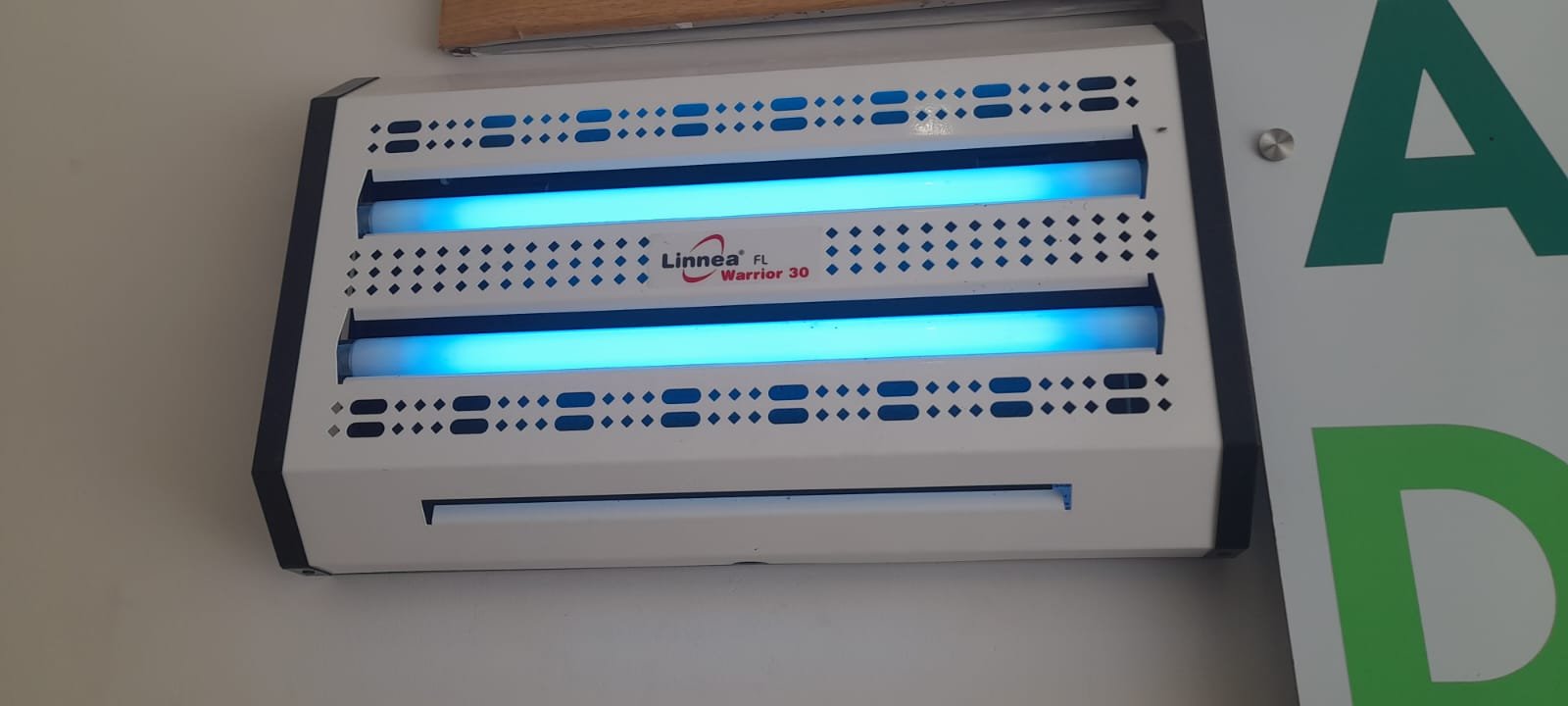 Wall-mounted UV fly trap installation